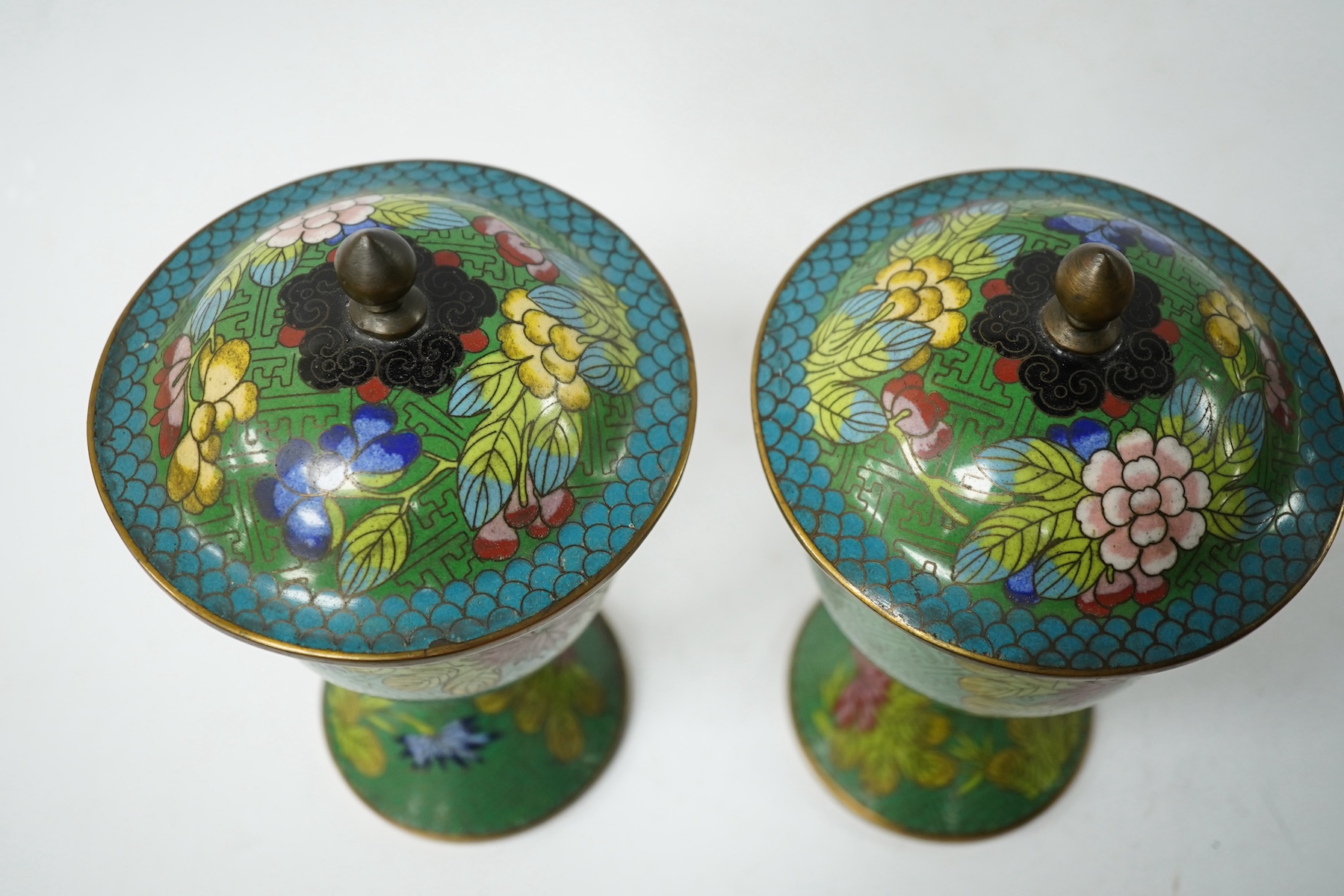 A pair of Chinese champleve enamel floral jars and covers, 22cm high. Condition - good